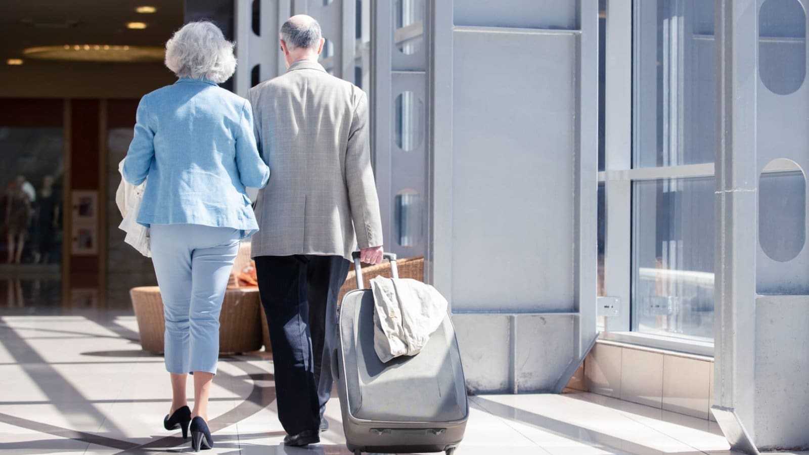 retired couple catching a flight on a holiday